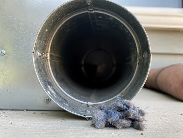 Sharon Dryer Vent Cleaning technician using specialized equipment to clear severe dryer vent blockage in Sharon